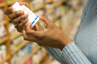 Proposition 65 - Woman looking at a prescription label.